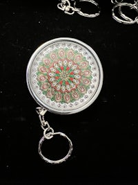 a key ring with a flower pattern on it