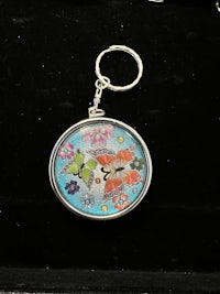 a key chain with a butterfly on it