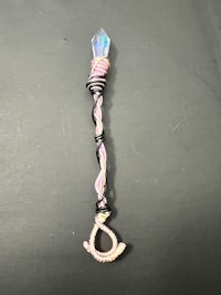 a pink and black wand with a wand attached to it