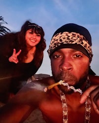 a man and a woman posing for a picture on the beach