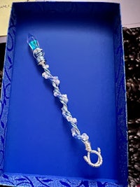 a blue and silver necklace in a blue box