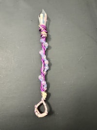 a pink and purple key with beads on it