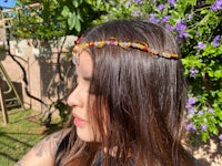 a woman wearing a colorful beaded headband