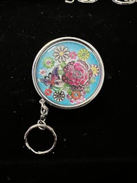 a key chain with a flower on it