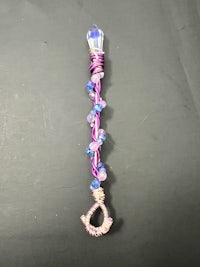 a purple and blue wand with beads on it