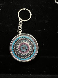 a mandala key ring with a blue and purple design