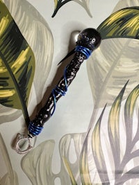 a black and blue pipe with a blue cord on it