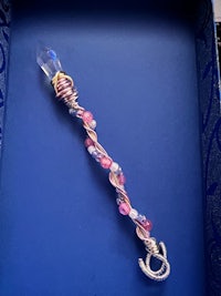 a blue box with a pink beaded key ring