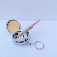 a key ring with a key and a pen in it