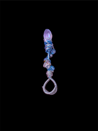 a blue and purple necklace hanging on a black background