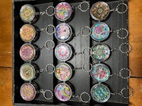 a group of colorful keychains in a wooden box