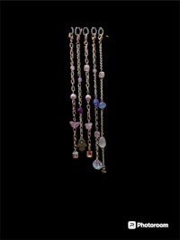 a group of necklaces with different colored beads on them