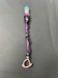 a purple and black wand with a purple handle