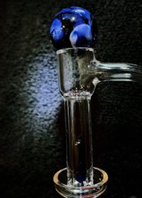 a glass pipe with a blue and black design