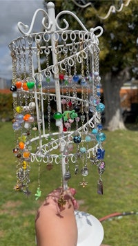 a person is holding up a holder full of beads