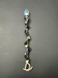 a black and blue necklace with a star on it