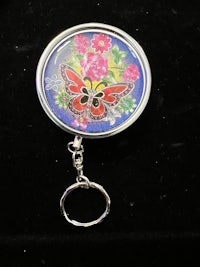 a key ring with a butterfly on it