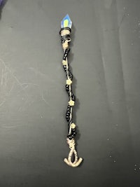 a necklace with a light attached to it