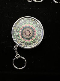 a mandala keychain with a circular design on it