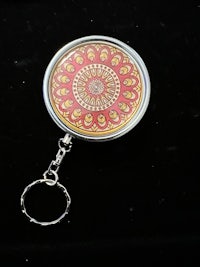 a key ring with a mandala design on it