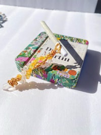 a small box with a cigarette on top of it