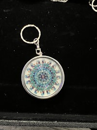 a mandala keychain in a box