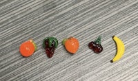 a group of fruit shaped pins on a table