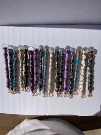 a group of bracelets with different colored beads on them