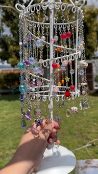 a person is holding a ring holder full of beads